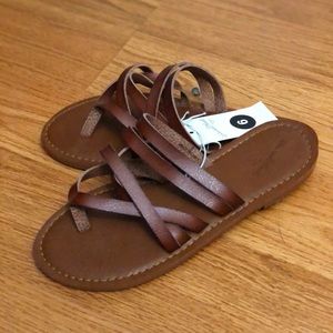 Never worn universal tread Dark tan sandals
